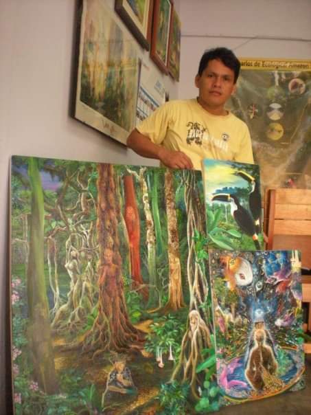 David Amaringo holding multiple paintings