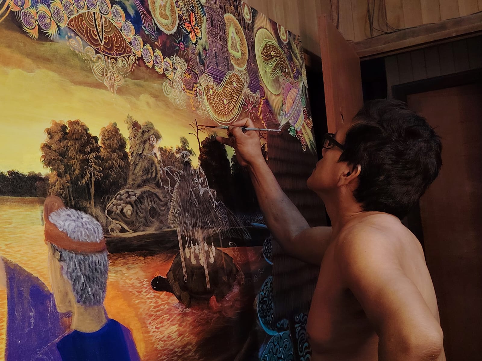 David Amaringo continuing work on a wall mural