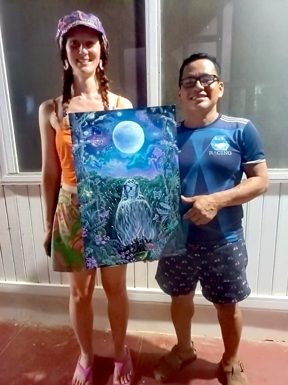 David Amaringo and a friend with a completed painting